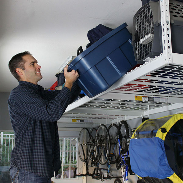 person removing bin from overhead rack