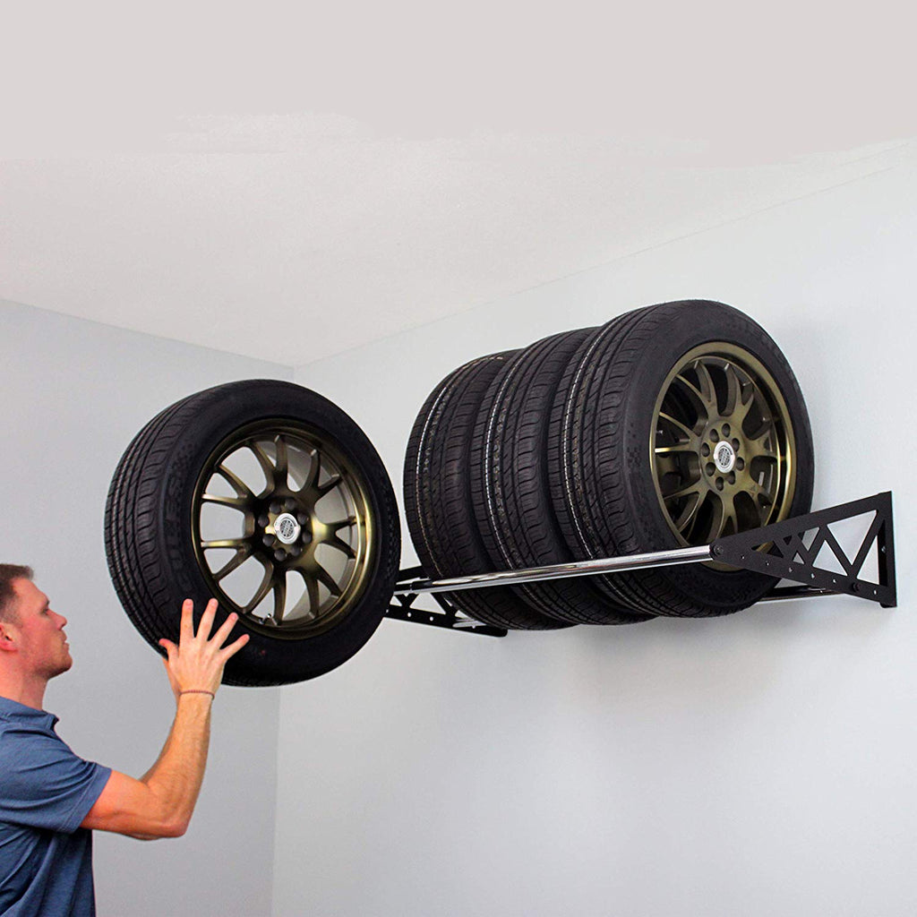 person loading tires on tire rack
