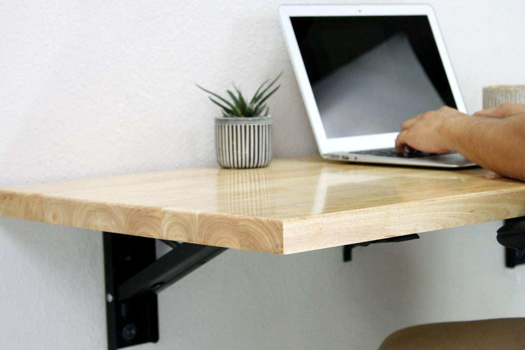 person using laptop on a folding workbench