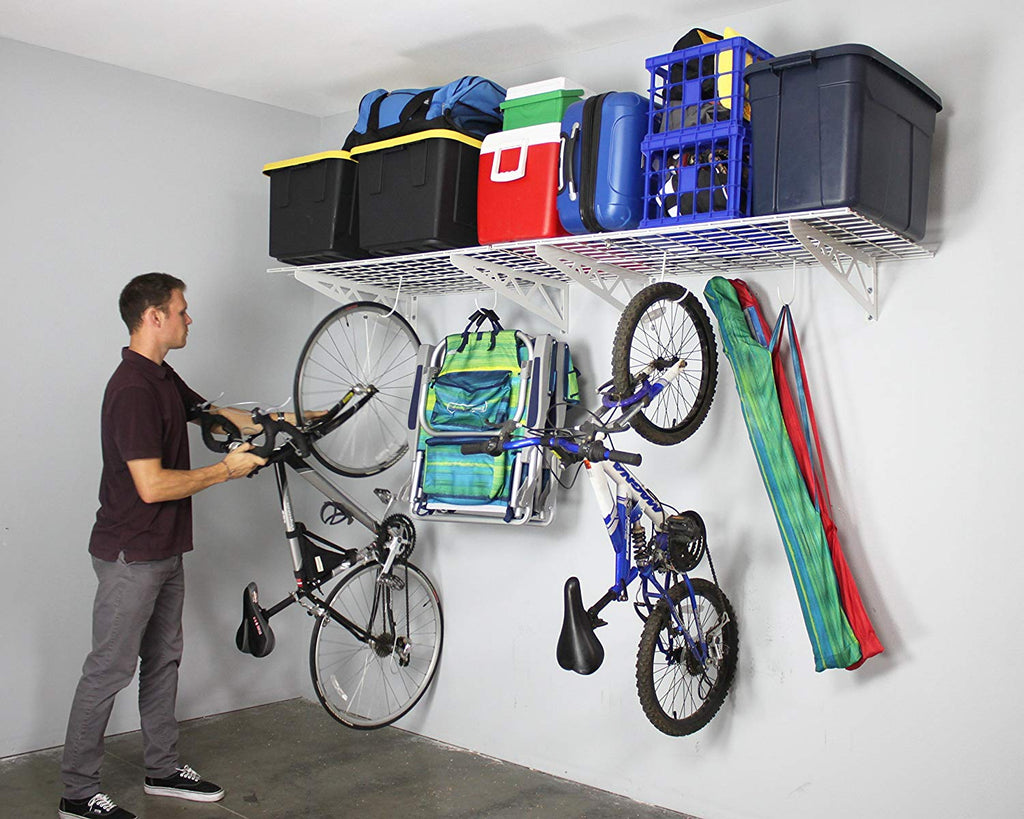 person removing bicycle from wall shelf hook