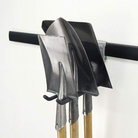 close up of wall rail hook with shovels 