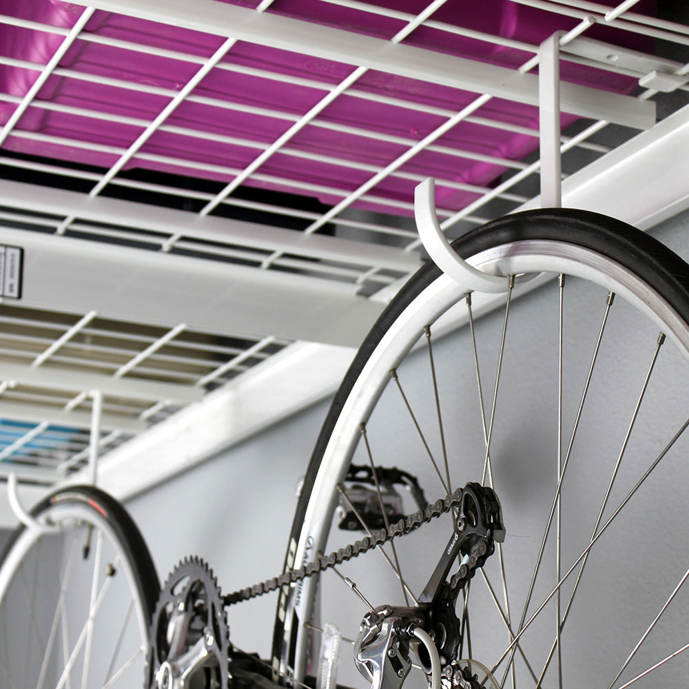 bicycle hanging from deck hooks on overhead rack