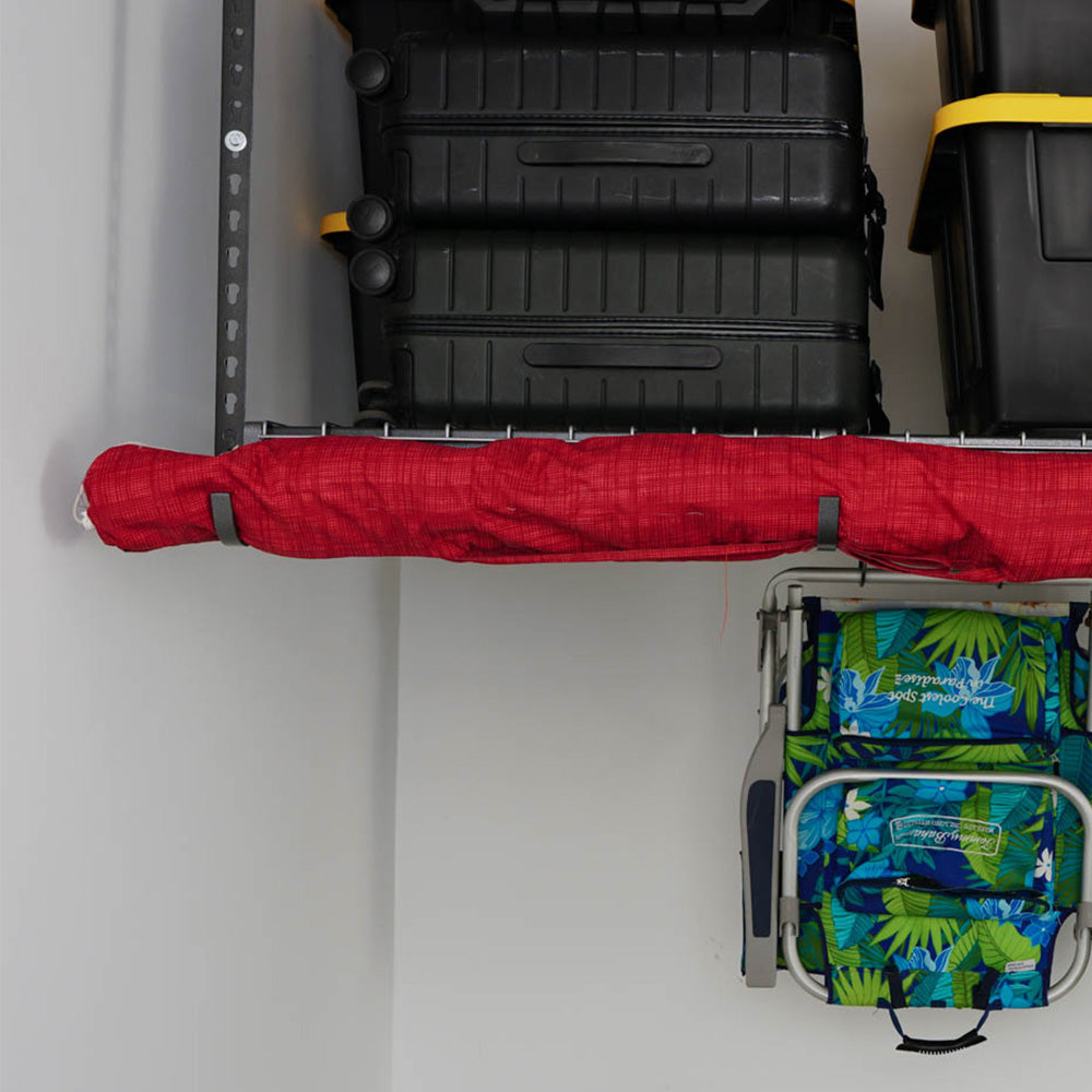 red beach umbrella hanging from overhead rail hooks