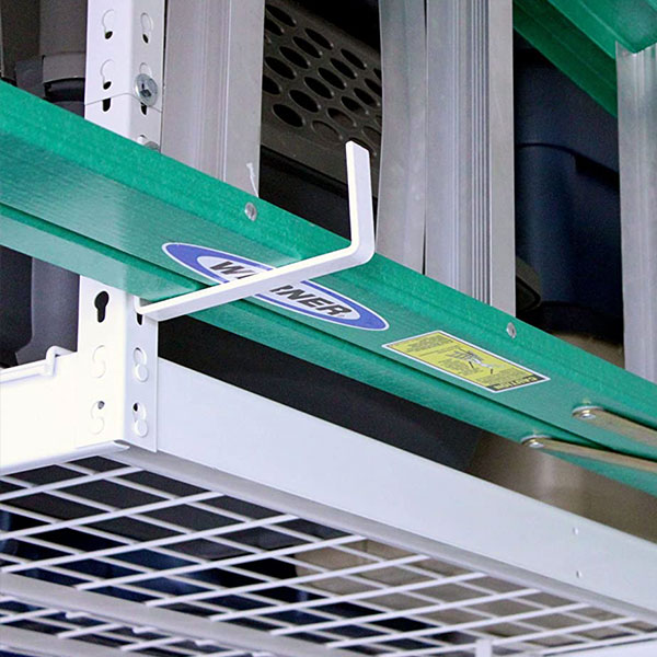 green ladder hanging from overhead rack hook